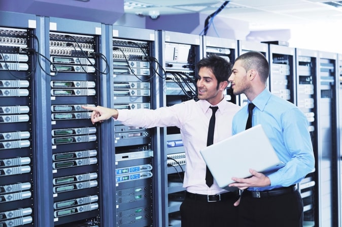 engineers pointing at data center equipment