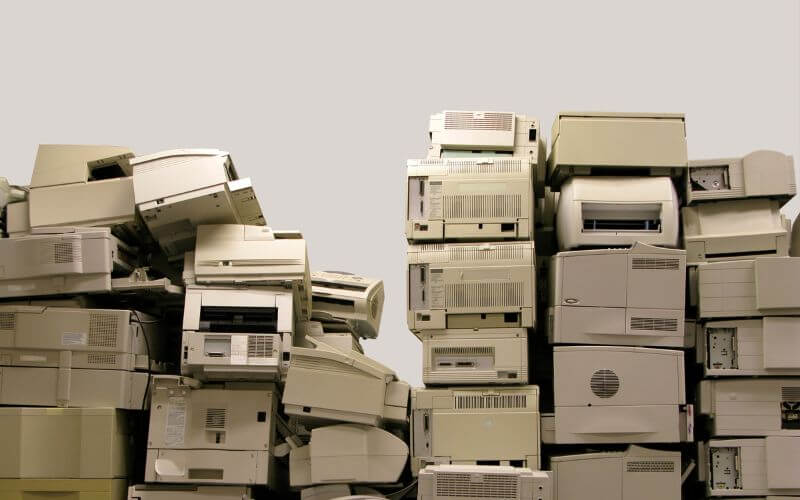 pile of printers for disposal